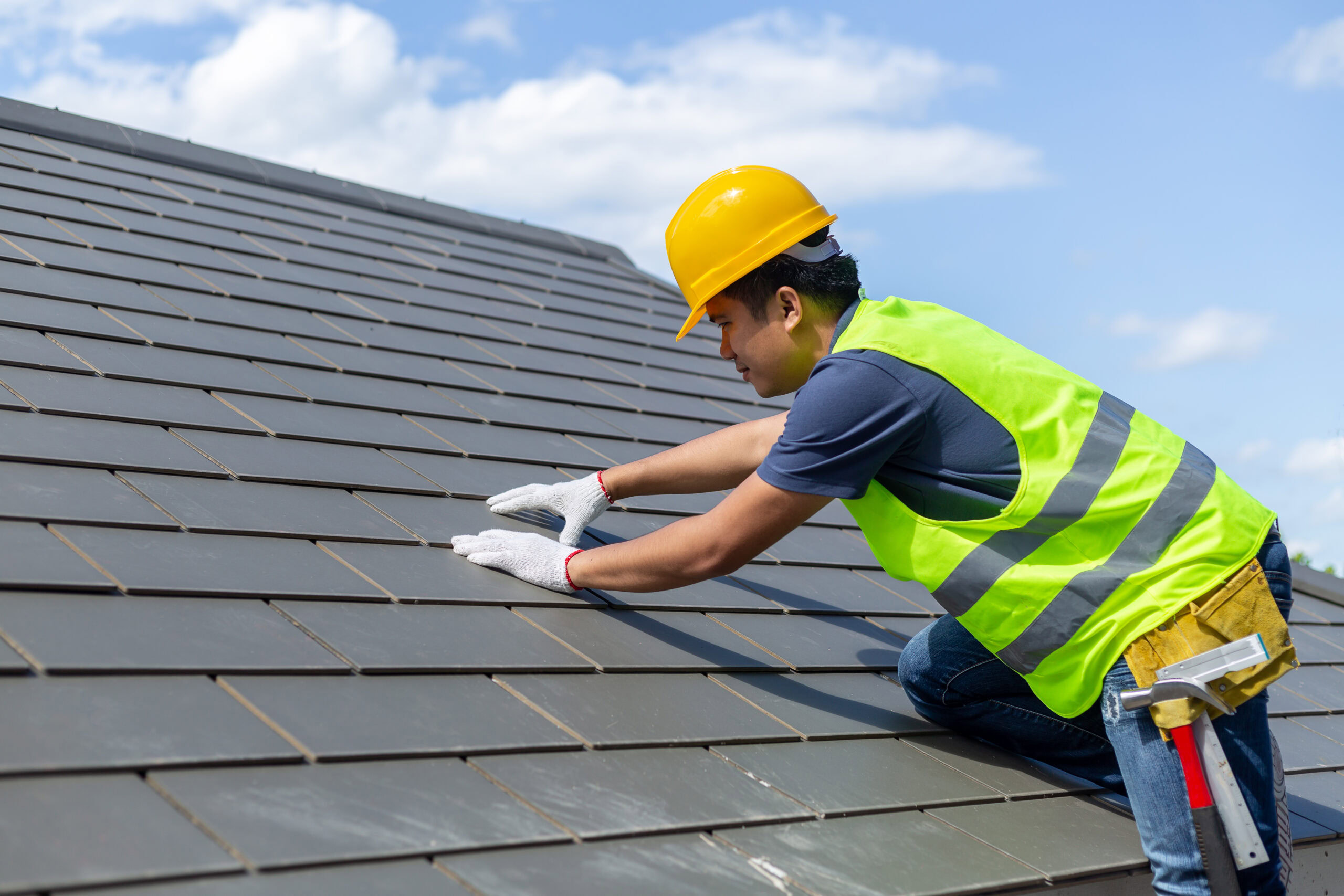 Man inspecting a roof's condition.